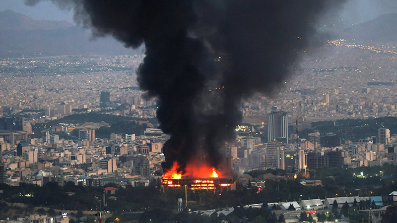 Smoke rises above Tehran after a reported Israeli strike targeted the headquarters of IRINN, Iran’s state news channel, on June 16, 2025