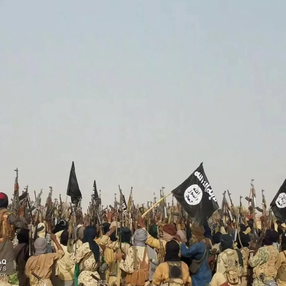 ISIS militants, holding their flags and firearms